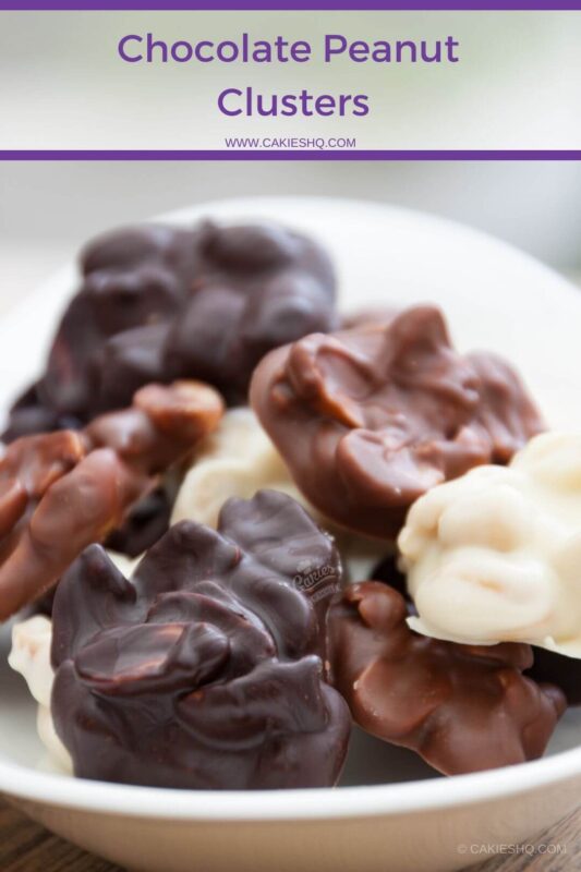 dark, milk and white chocolate peanut clusters on a white serving dish