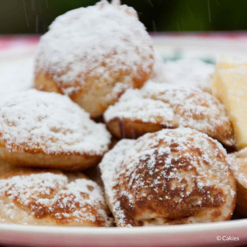 Poffertjes are a traditional Dutch treat. Mini, fluffy pancakes made with yeast and buckwheat flour. Typically eaten sprinkled with confectioner's sugar. #poffertjes #dutchrecipe #dutchrecipes #minipancakes